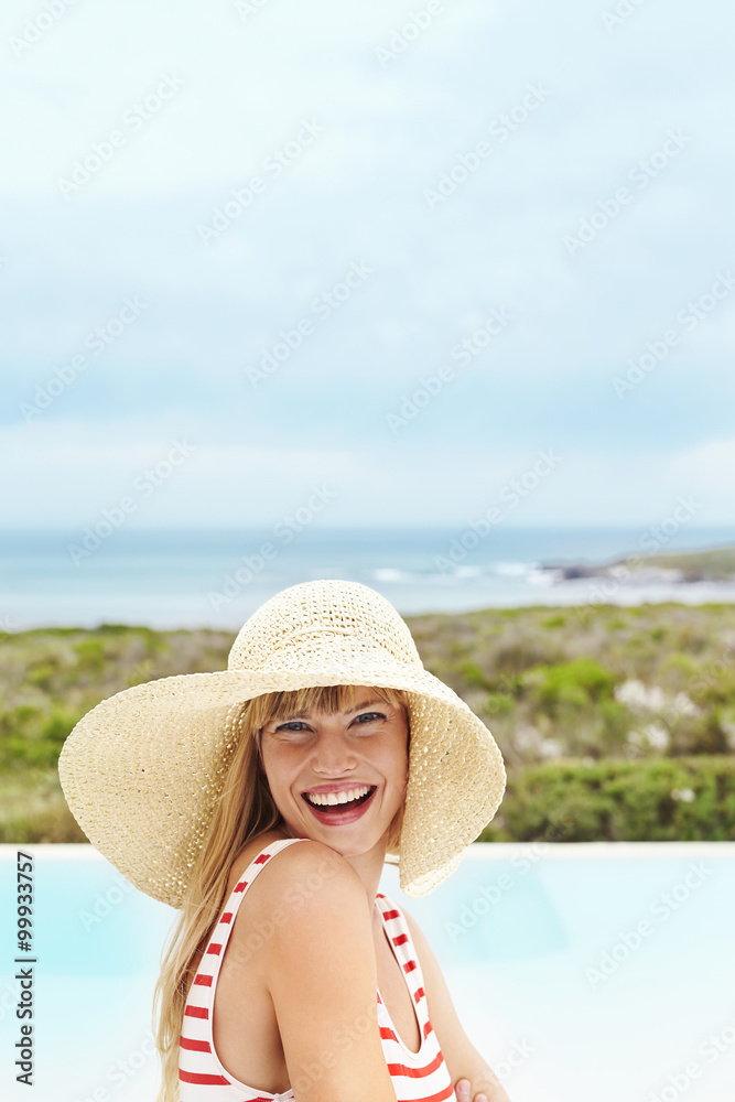 Laughing young model in sunhat, portrait