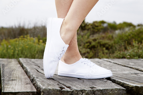 Close up of model in white sneakers