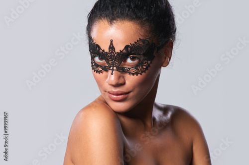 Closeup portrait of beautiful mixed race with black lace mask