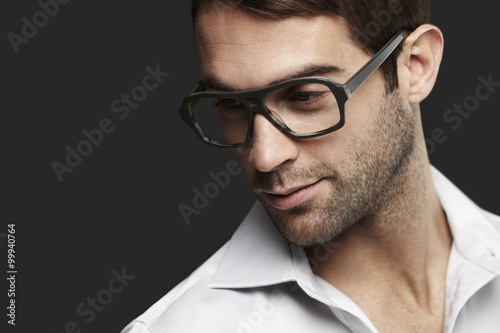 Fototapeta Naklejka Na Ścianę i Meble -  Young man in spectacles looking away
