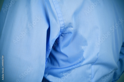 man with an underarm sweat stain