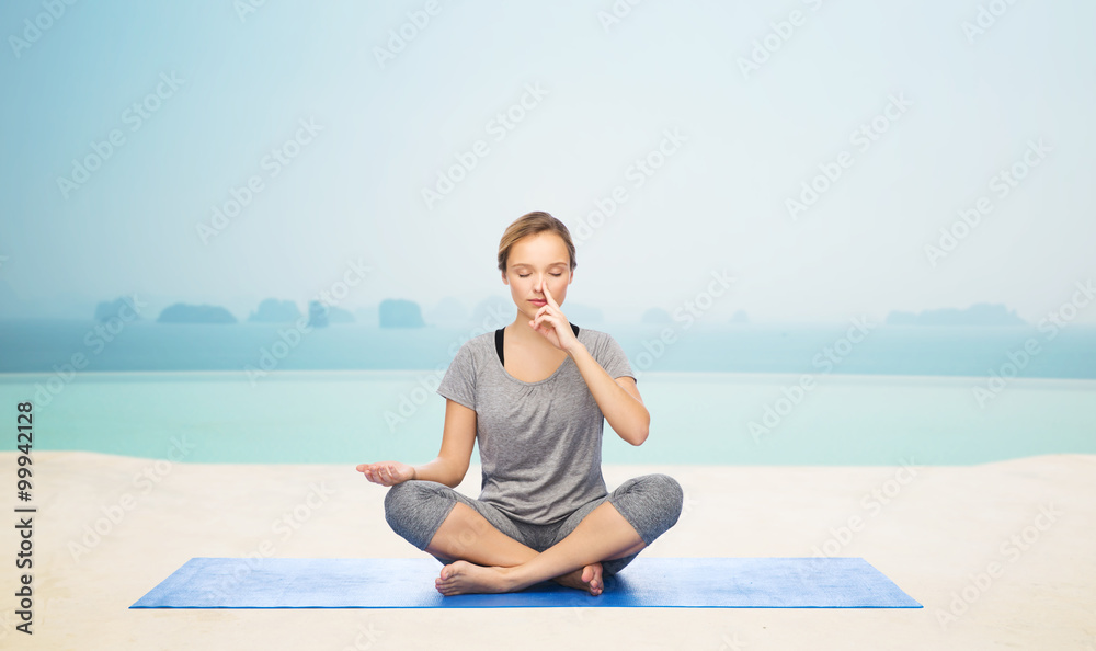 woman making yoga meditation in lotus pose on mat woman making yoga meditation in lotus pose on mat