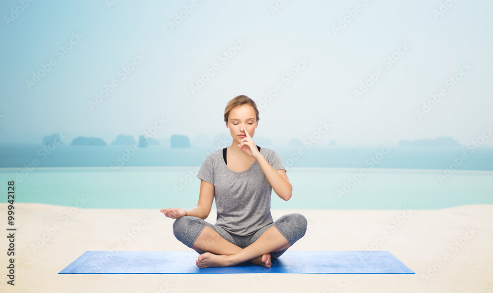 woman making yoga meditation in lotus pose on mat