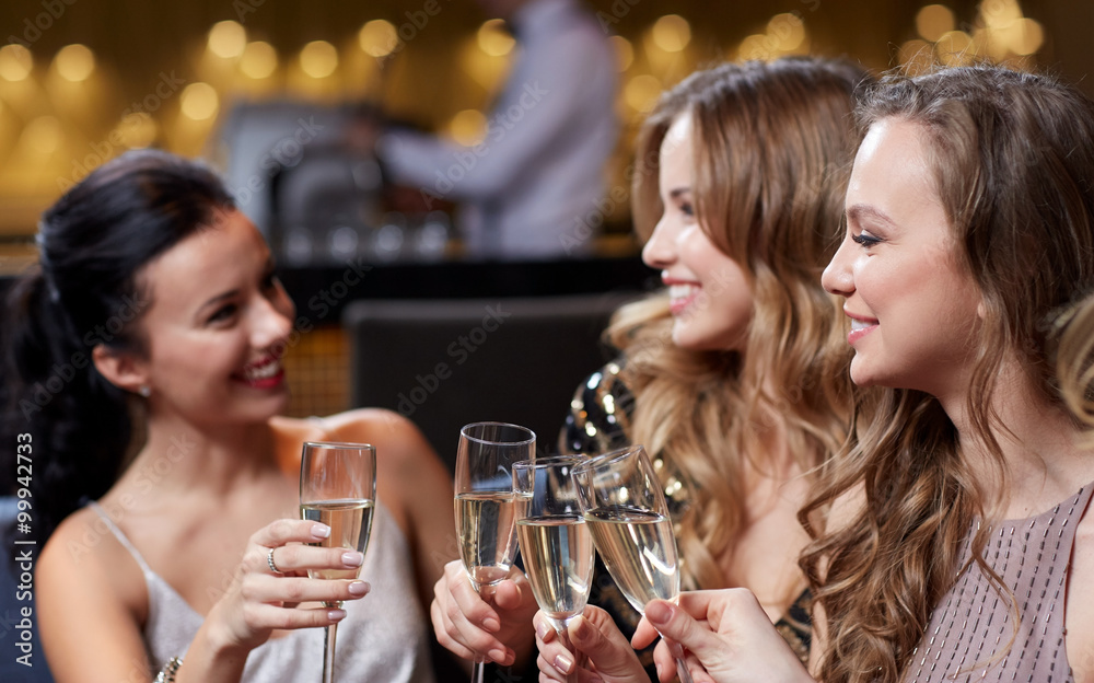 happy women with champagne glasses at night club happy women with champagne glasses at night club