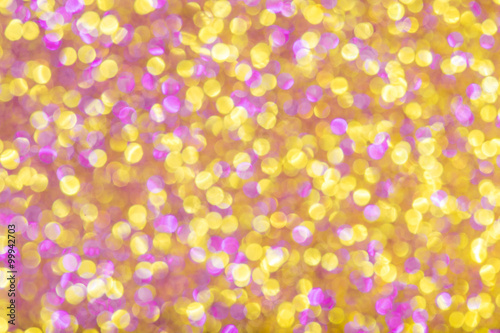 Pink and golden defocused glitter background.