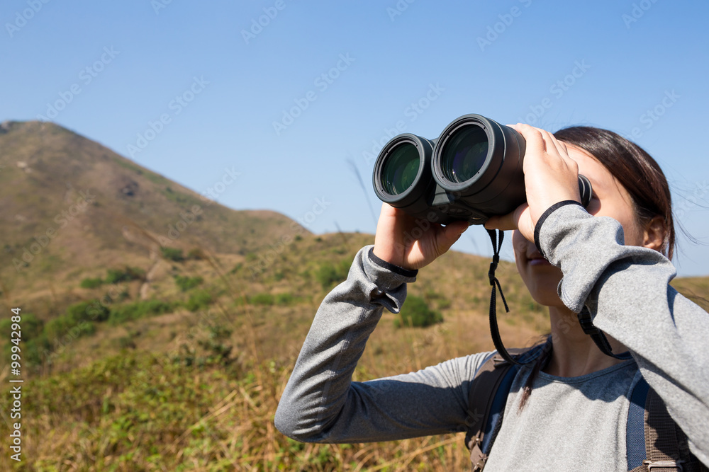 Young Woman watching though binocular
