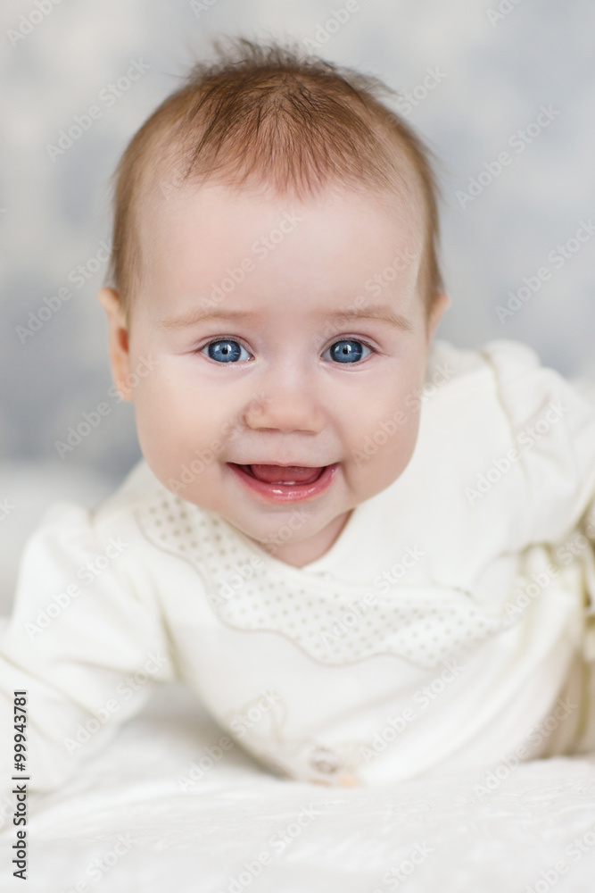 Portrait of a crawling baby on the bed in her room Portrait of a crawling baby on the bed in her room