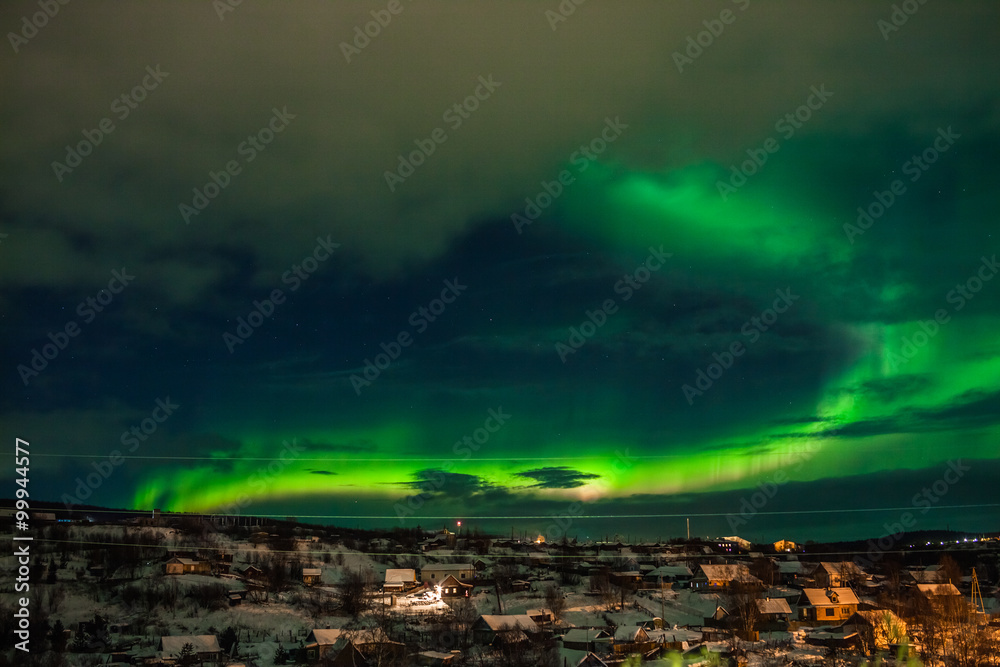 Nothern lights over smal village. Aurora Borealis