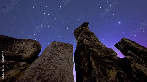 Astronomical time-lapse looking up rock pillars at Mount Arbel. photo