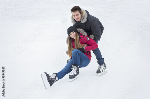 Ice skating couple having winter fun on ice skates Quebec, Canada.