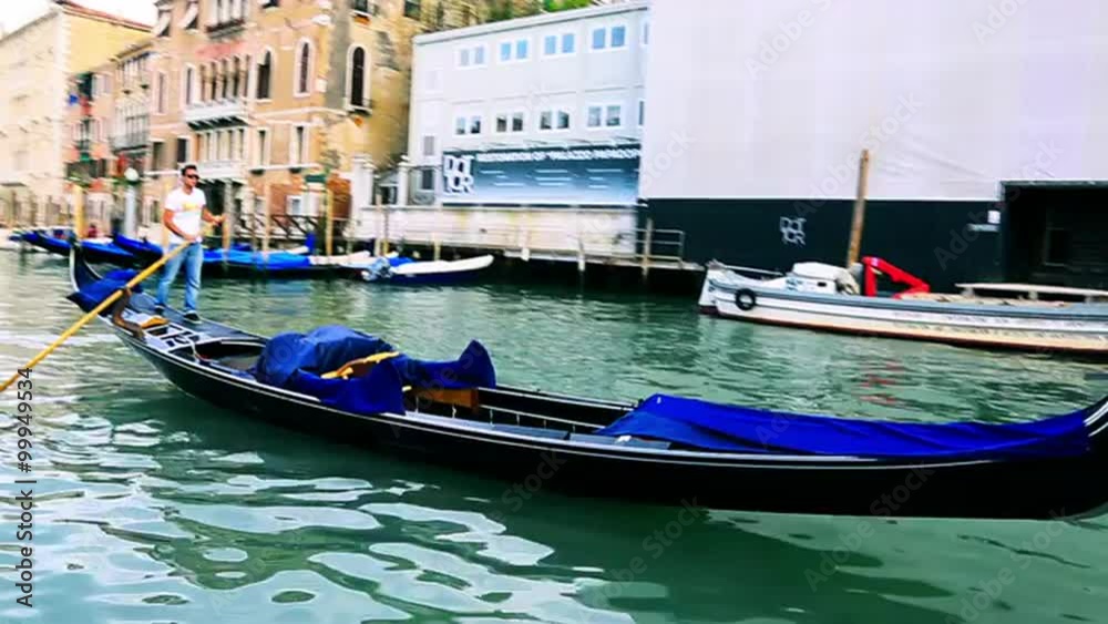 Tracking shot of a gondola moving in a canal, Grand Canal, Venice, Veneto, Italy Tracking shot of a gondola moving in a canal, Grand Canal, Venice, Veneto, Italy