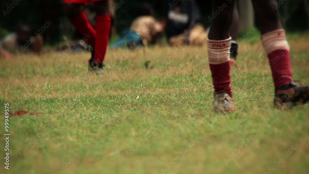 Children walking around and wearing football cleats, socks, and shin guards Children walking around and wearing football cleats, socks, and shin guards