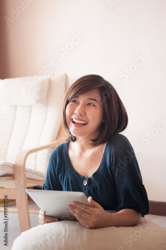 Young asian woman holding blank digital tablet.