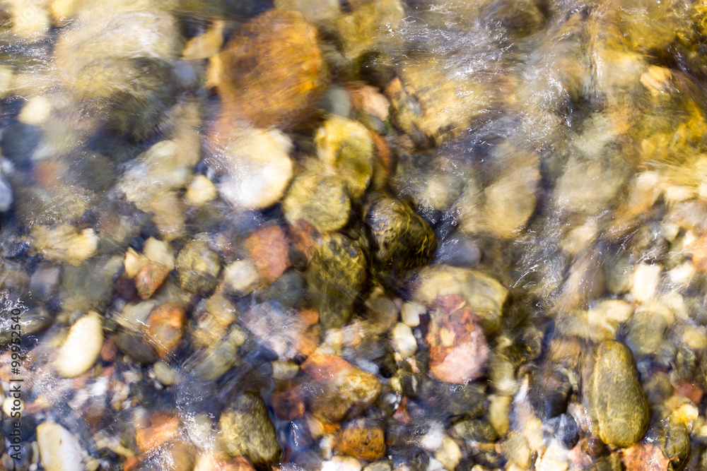 colored stones under water as background colored stones under water as background