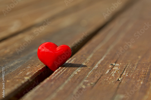Red heart on a wooden surface