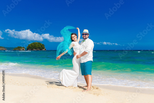 Beautiful brunette bride in white wedding dress with turquoise v