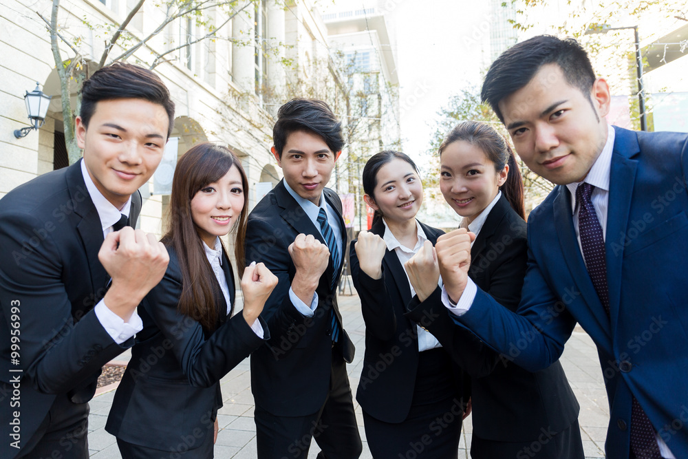 Group of business people cheerp up with holding arm fist togethe Group of business people cheerp up with holding arm fist togethe