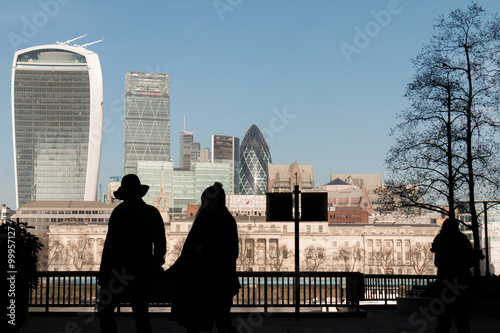 Silhouetted figures against a sunlit London skyline on the Southbank photo