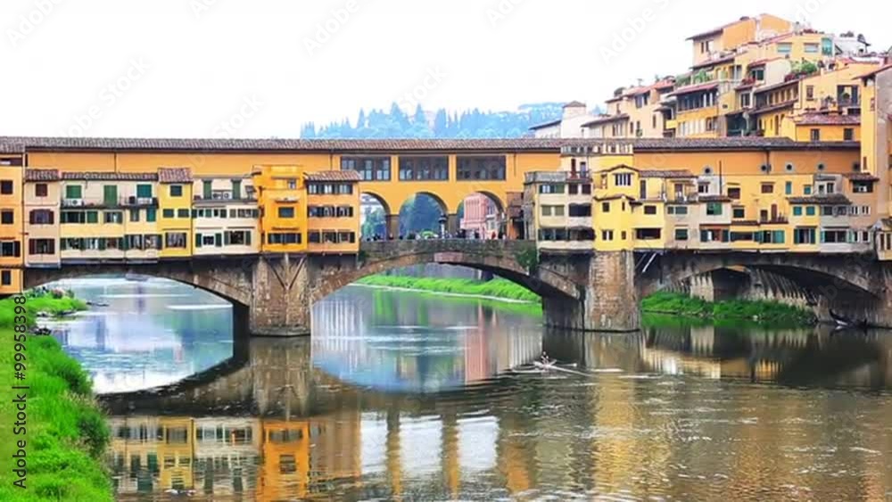 Locked-on shot of an arch bridge, Ponte Vecchio, Arno River, Florence, Tuscany, Italy Locked-on shot of an arch bridge, Ponte Vecchio, Arno River, Florence, Tuscany, Italy
