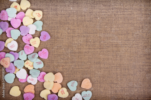 Candy conversation hearts on a brown background