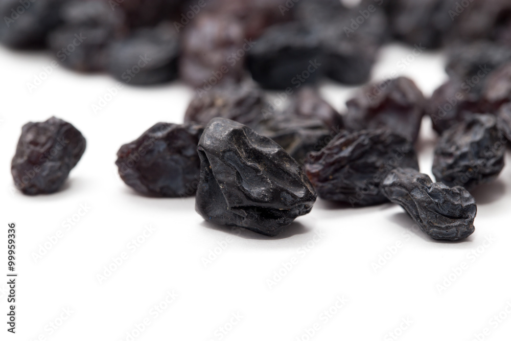 Black raisins on a white background. macro Black raisins on a white background. macro