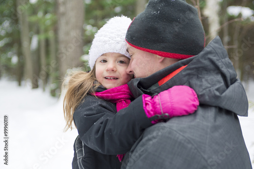 Father and daughter outdoor in the winter forest