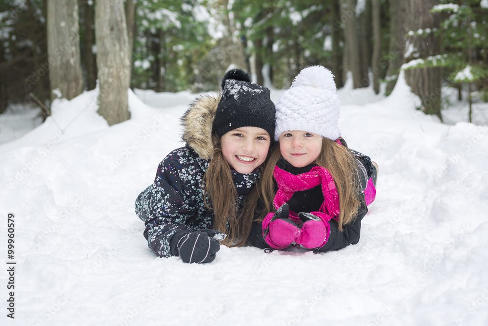 Two girls looking at camera in winter park