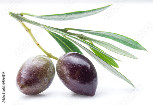 Two fresh olives with leaves on the white background.