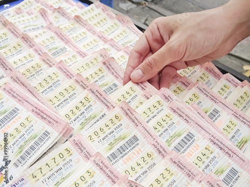Woman hand picking Thai lottery in Bangkok photo