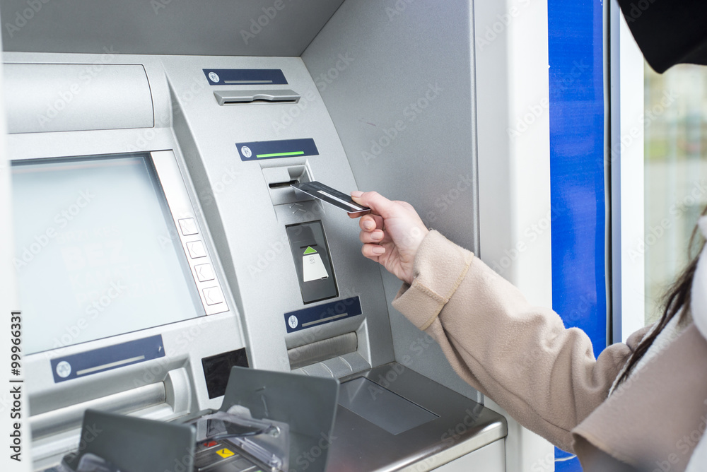 Young woman using the ATM Young woman using the ATM