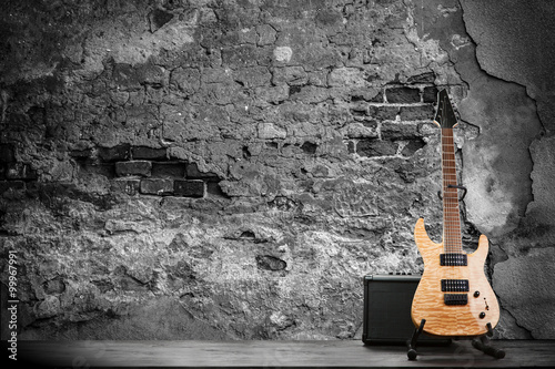 Electric guitar on a brick wall background © George Dolgikh