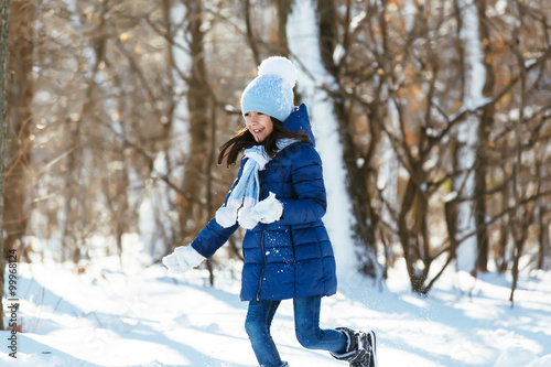 Little girl outdoors on beautiful winter snow day