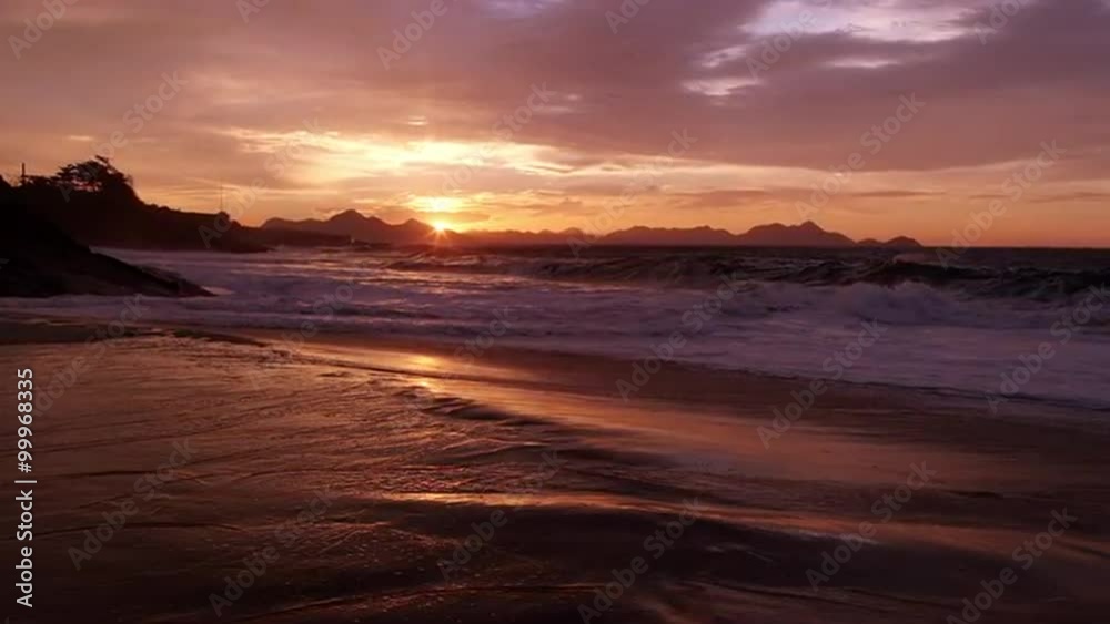 Golden sunset sunrise over beach with crashing waves on the surf of praia vermelha (Devil's Beach) Rio de Janeiro, Brazil. Golden sunset sunrise over beach with crashing waves on the surf of praia vermelha (Devil's Beach) Rio de Janeiro, Brazil.