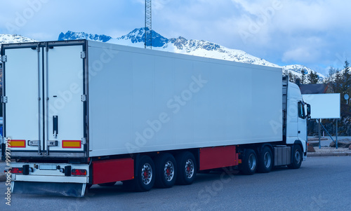 White refrigerated truck on background of the mountains