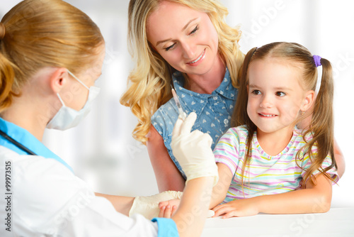 Doctor  pediatrician makes child vaccination