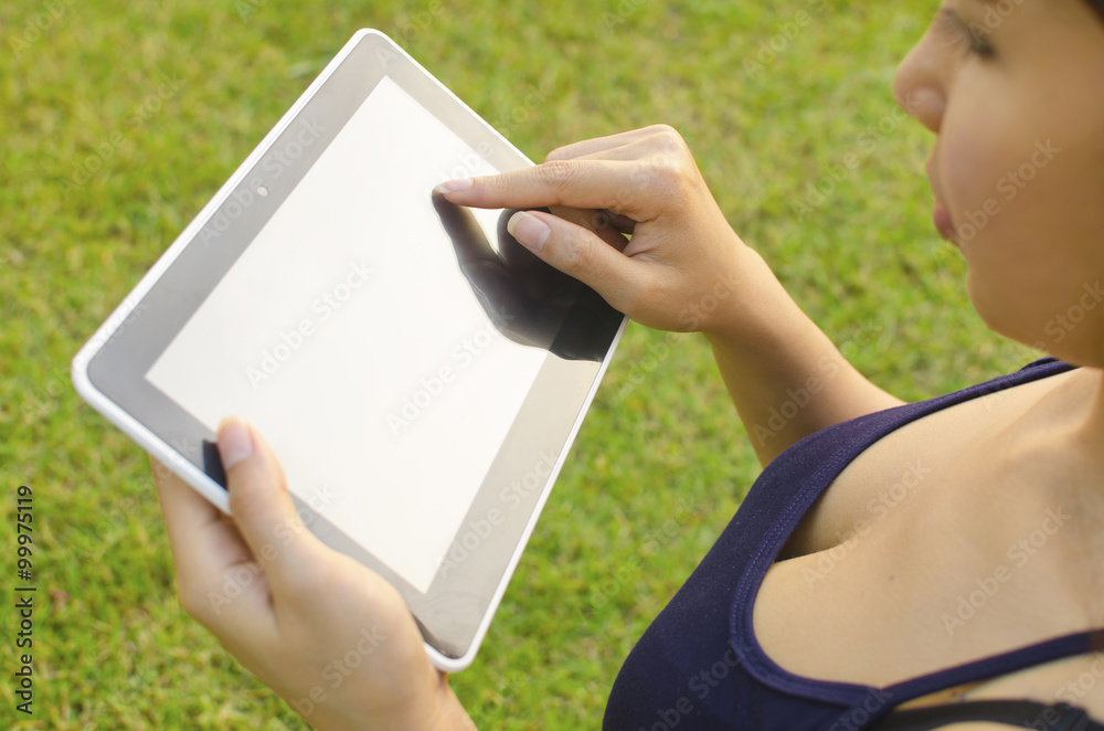 Woman using digital tablet outdoors