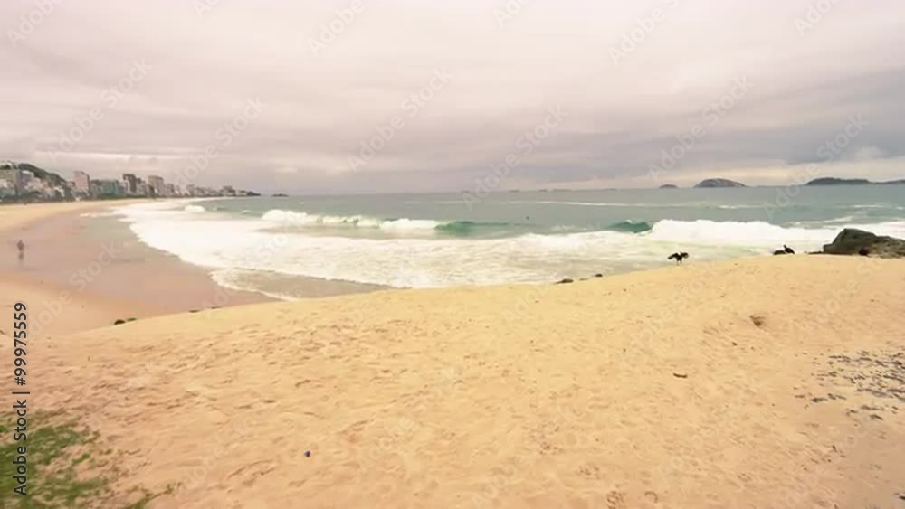 Slow motion pan of man doing headstand on the beach in Rio de Janeiro, Brazil Slow motion pan of man doing headstand on the beach in Rio de Janeiro, Brazil