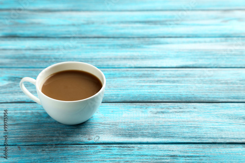 Cup of coffee on a blue wooden table