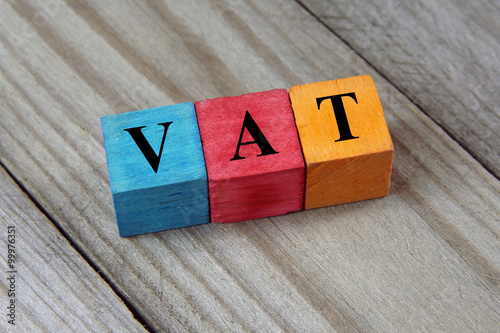 VAT text (Value Added Tax) on colorful wooden cubes photo
