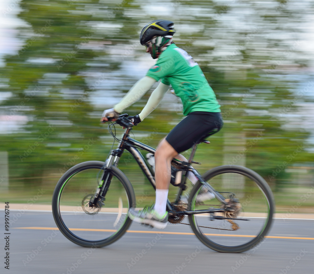 Fototapeta premium Riding a bike on a street motion blur