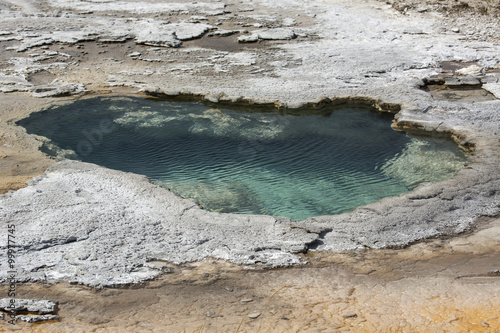 Aqua water of thermal pool in limestone rock of Yellowstone Park, Wyoming.