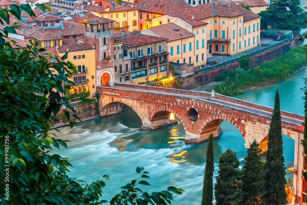Ancient Roman bridge Ponte Pietra and the River Adige at evening, view from Piazzale Castel San Pietro, Verona, Italy