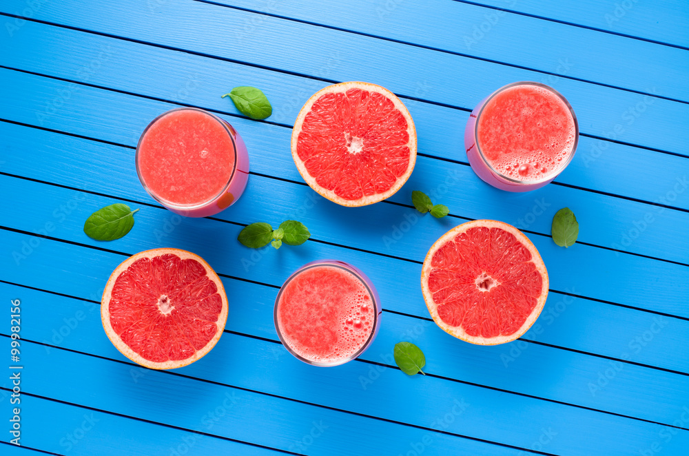 Grapefruit juice on blue wooden table Grapefruit juice on blue wooden table