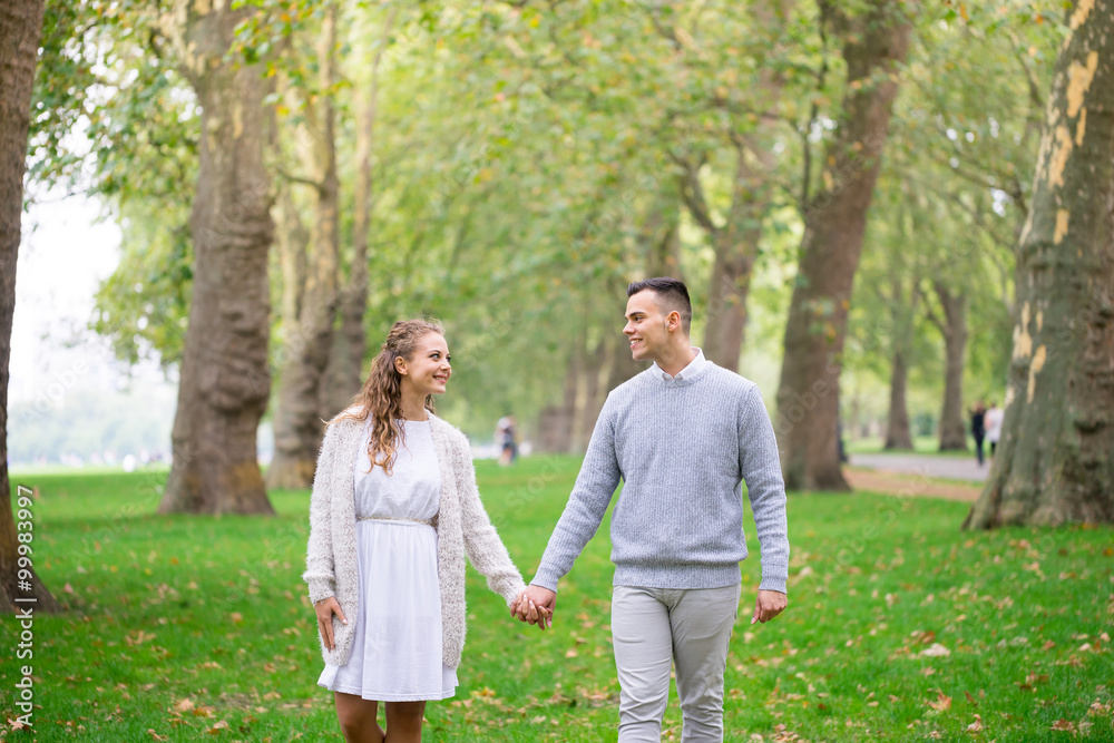 A couple walking in the Hyde Park, London A couple walking in the Hyde Park, London