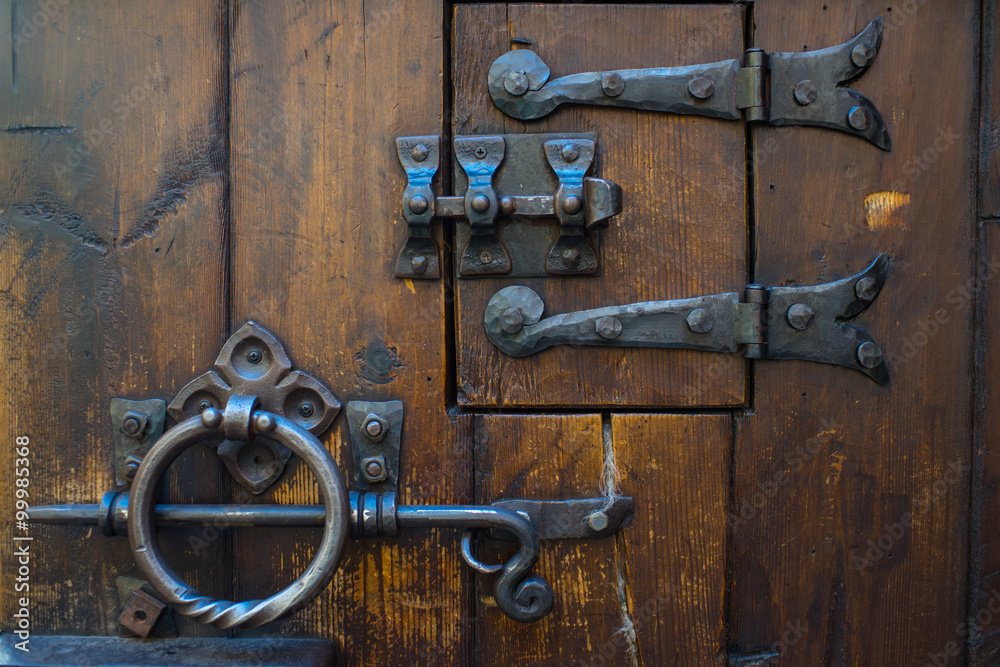 Medieval door lock. Oak door with iron lock. Stock Photo | Adobe Stock