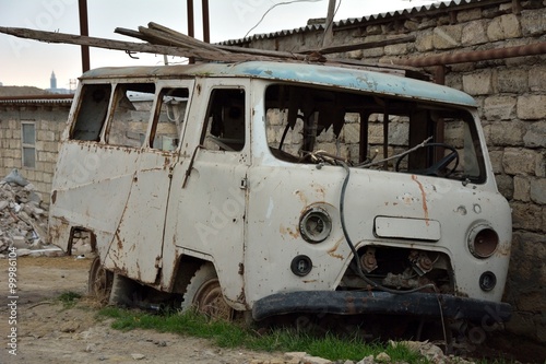 Rusting abandoned van in Baku, capital of Azerbaijan. A long abandoned van is slowly destroyed by nature   © iredding01