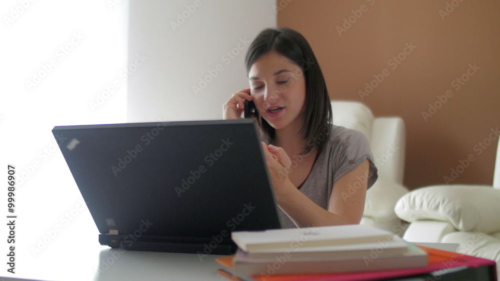 Nice girl browsing internet talking over the phone at home Nice girl browsing internet talking over the phone at home