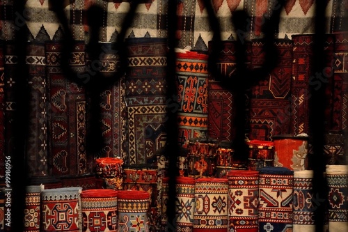 View into a carpet shop through wrought iron window in Baku's Old City. A scene from a UNESCO world heritage site in Baku, the capital of Azerbaijan
