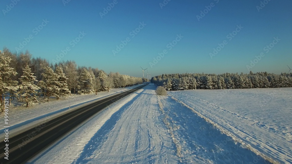 aerial view at the winter road with windmills aerial view at the winter road with windmills