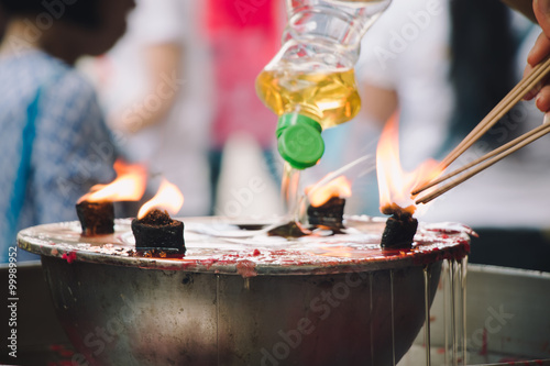 Burning Joss stick and oil palm candle at chinese shrine for making merit in chinese new year festival. Pray for New Year, Lighting incense to Buddha.